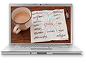 Laptop screen showing an open journal and a mug of coffee.