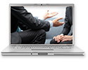 Laptop with image of two people facing each other that is zoomed in to only show partial torso and hands