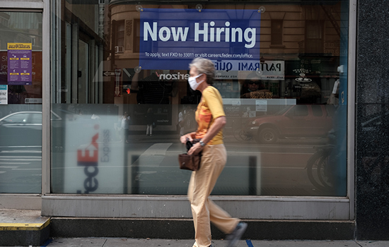 A hiring sign is displayed in a store window in Manhattan on Aug. 19, 2021, in New York City.